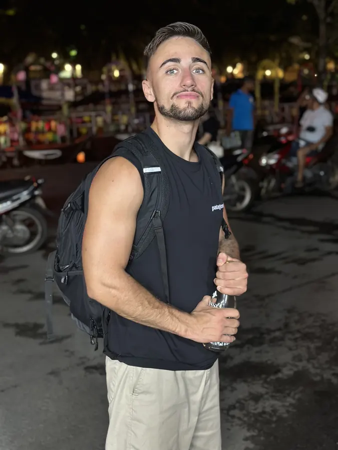 Federico with his backpack on a night street
